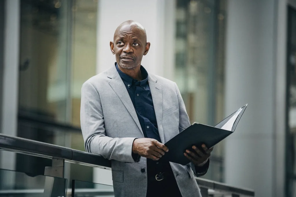 Businessman with folder on a patio